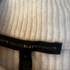 White House Black Market white and Black striped sweater with zipper detail.